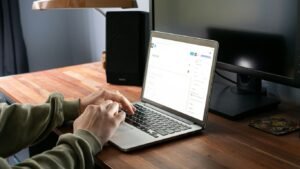 person in gray jacket using macbook pro