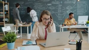 Woman celebrating success while on a business call.