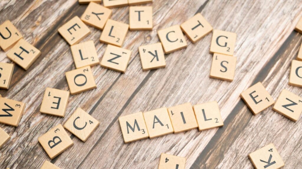 a close up of scrabble letters on a wooden surface