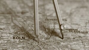 A compass resting on a map with "koln" visible.