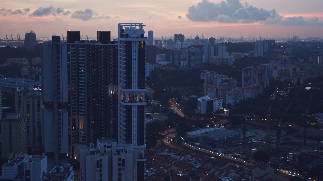grey and pink cloudy sunset sky over the city