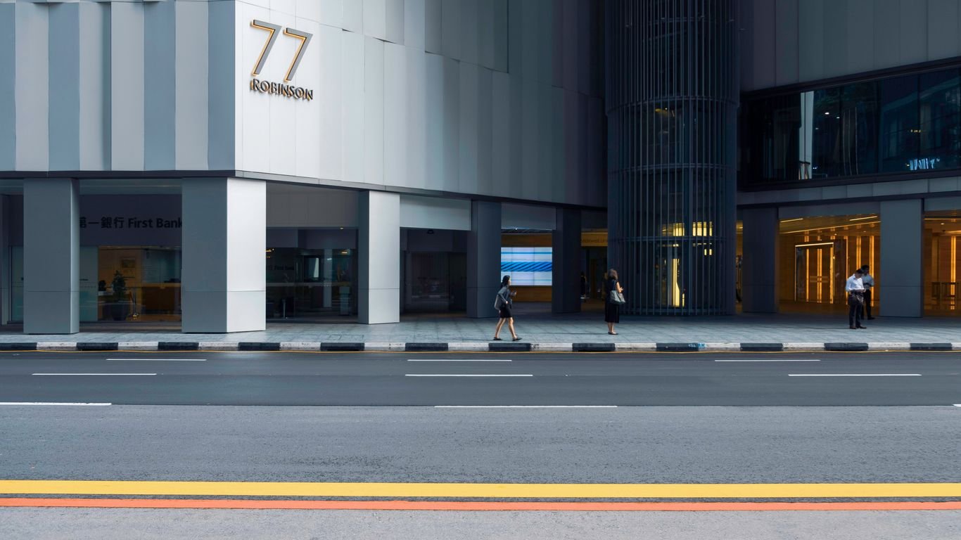 people on sidewalk by concrete building at daytime