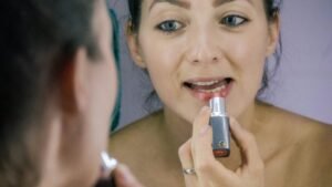 a woman brushing her teeth in front of a mirror