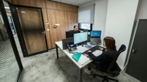 People work at desks in a modern office.