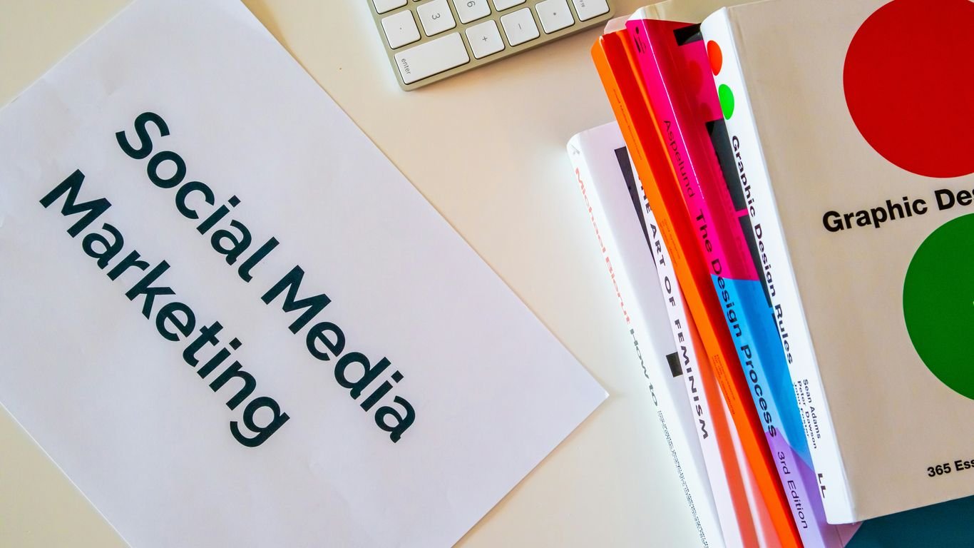 a sign that says social media marketing next to a keyboard
