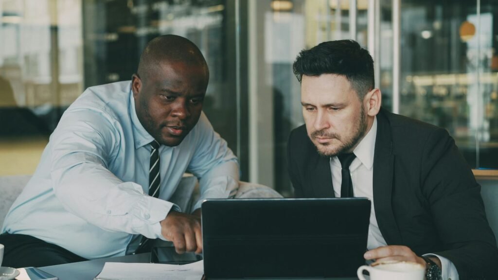 Two men looking at a laptop together