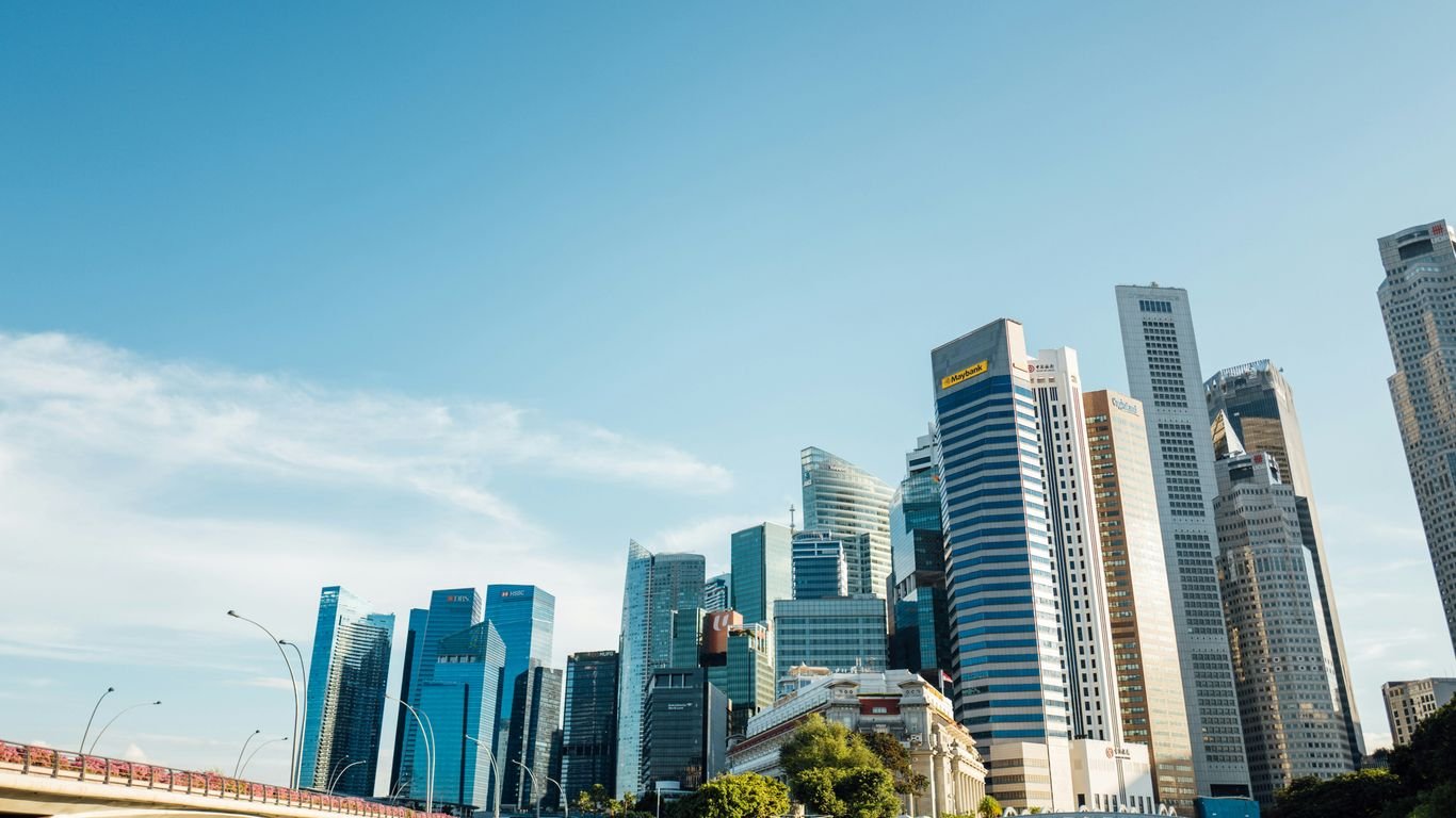 a city skyline with tall buildings and a bridge