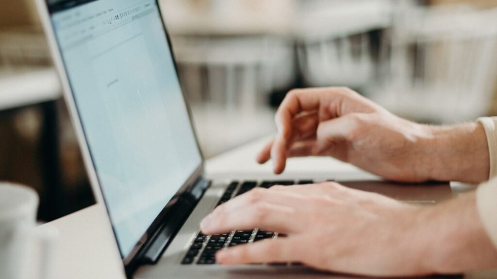 Laptop and phone displaying a Singapore retail brand's EDM email newsletter side by side