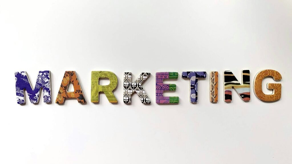 Wooden scrapbook letters spelling out the word marketing on a plain background