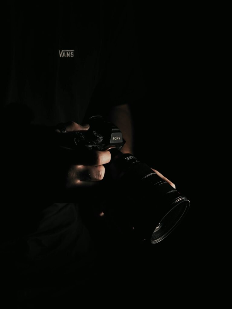 Hand holding a professional DSLR camera used for a Singapore business's professional photography