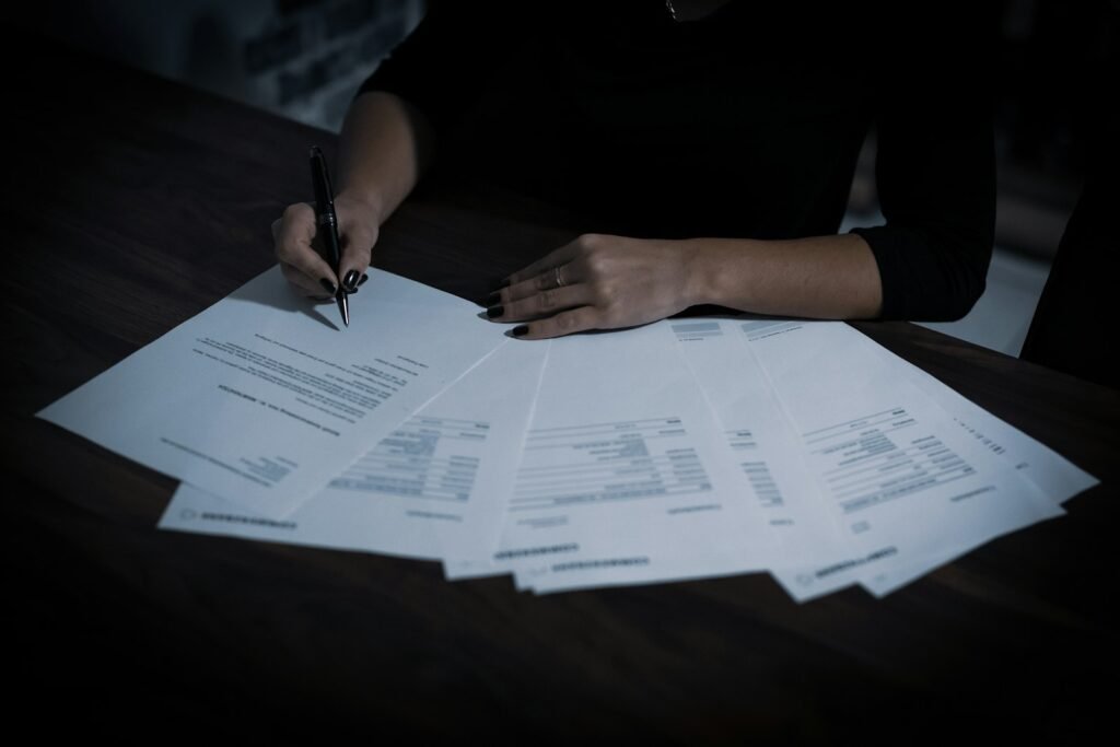Singapore business owner reviewing a stack of SEO service quotes and proposals on her desk