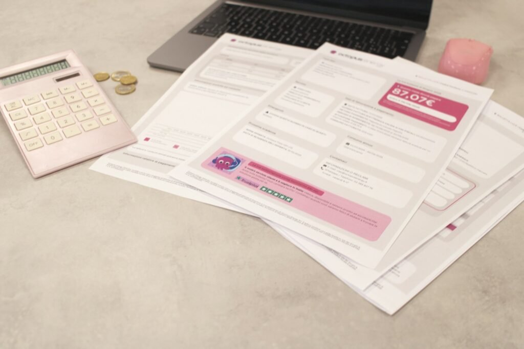 Bills and a calculator on a desk representing a Singapore business owner comparing digital marketing packages against their budget