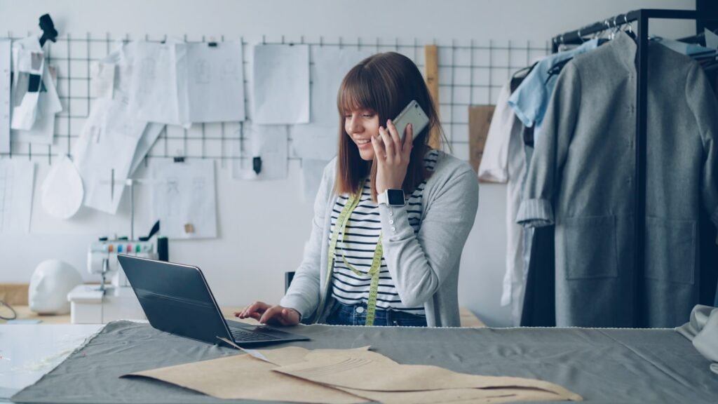 Singapore business owner juggling her laptop and a phone call, representing the reality of DIY digital marketing versus hiring an agency