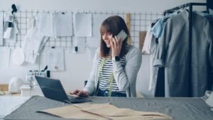 Singapore business owner juggling her laptop and a phone call, representing the reality of DIY digital marketing versus hiring an agency