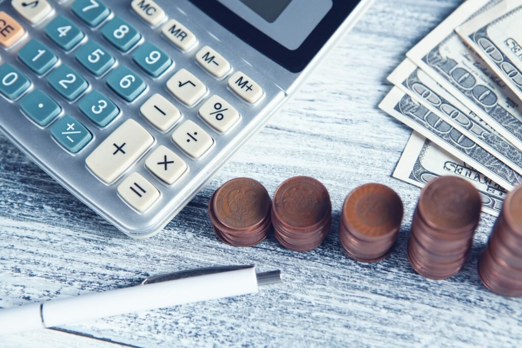 Calculator, pen and cash on a table, representing a Singapore SME deciding where to prioritise a limited marketing budget
