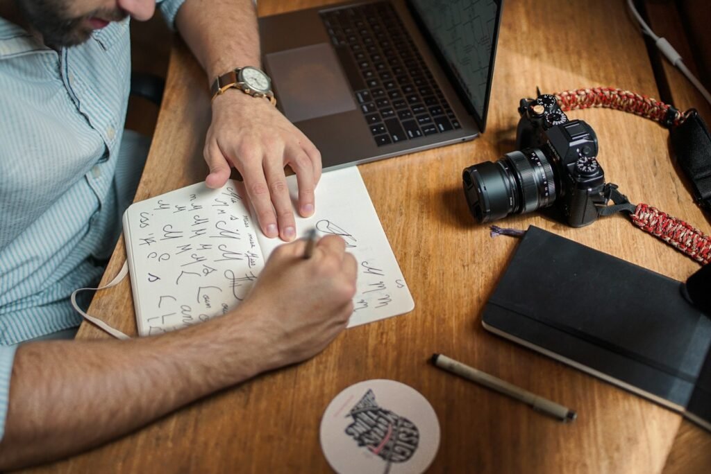 Content creator writing a script on paper in front of a camera while planning content that converts for a Singapore audience