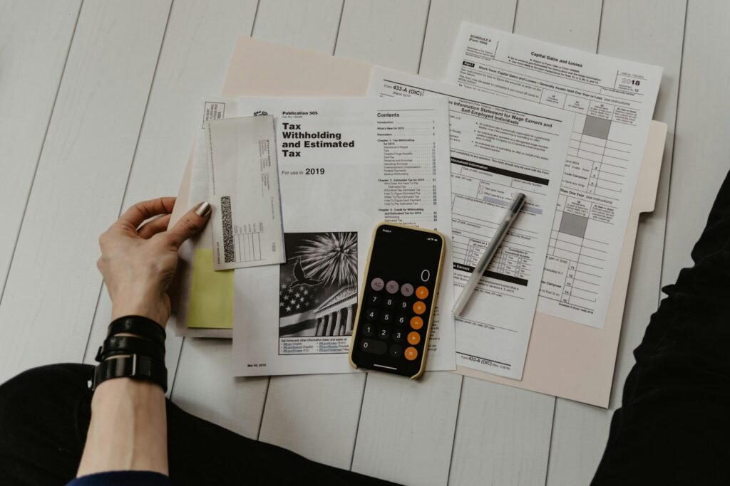 Documents and a calculator, representing advertising cost comparison