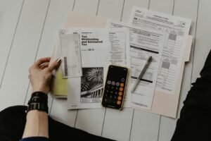 Documents and a calculator, representing advertising cost comparison