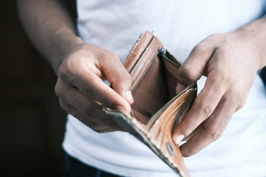 Person holding an empty wallet, representing overpaying for SEO services
