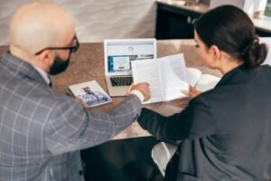 Business owner comparing SEO agency proposals with a consultant