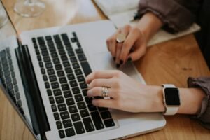Content writer typing on a laptop, representing content marketing for SEO and lead generation