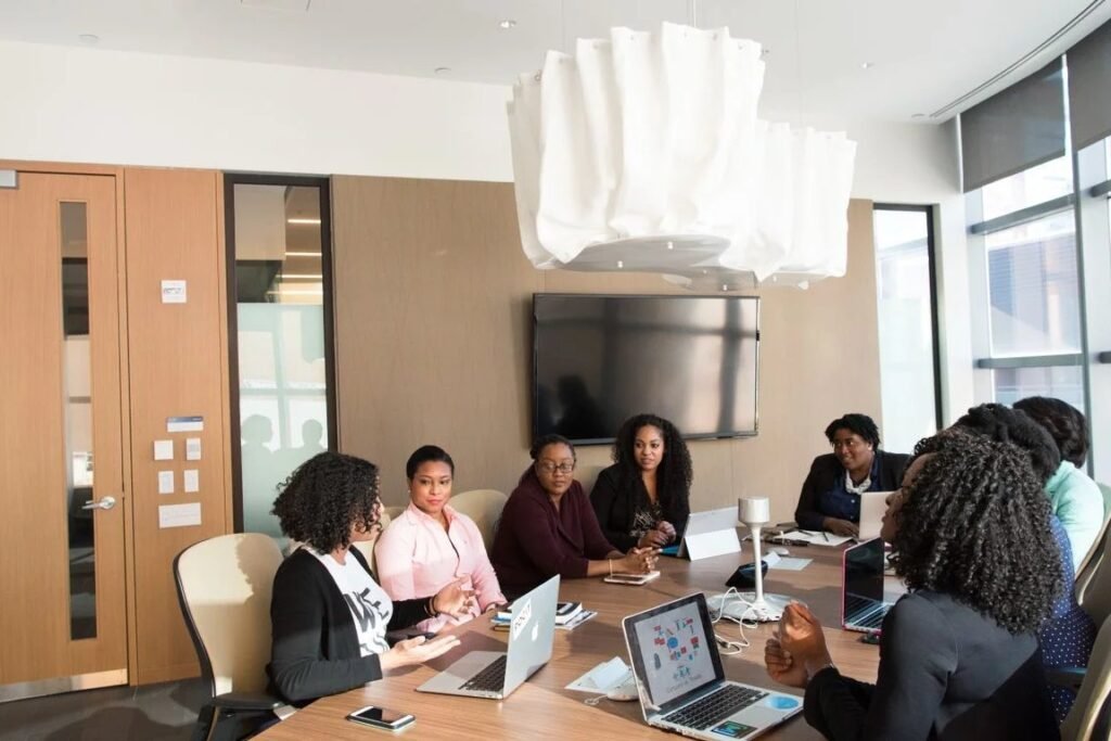 A printed content audit and a hand-drawn topic cluster map on a meeting table, showing the architecture work a content strategy consultant delivers.