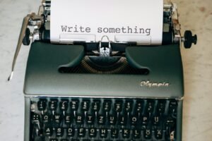 Typewriter with a page reading write something, representing copywriting services