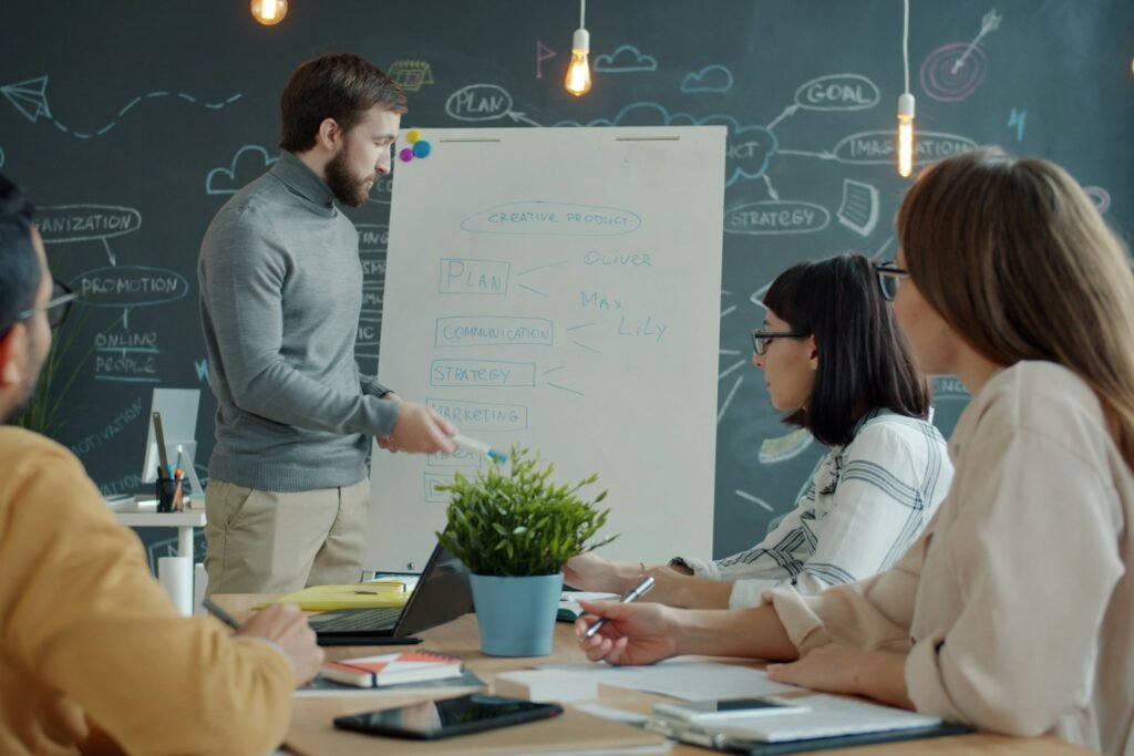 Team in a corporate branding strategy workshop, mapping brand positioning and messaging on a whiteboard