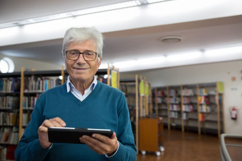 A marketing manager reviews a grid of corporate photo files on screen while building a social post from one of the images.