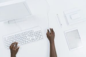 Two colleagues review a component library on screen while planning corporate website design services for a multi-department organisation.