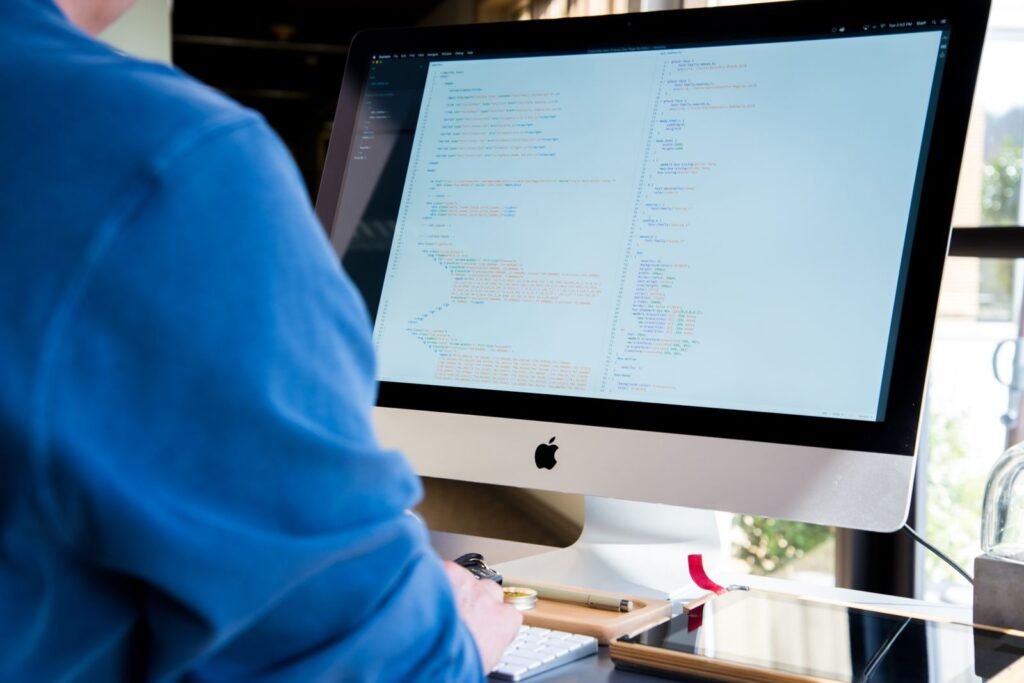A developer walks a business owner through a workflow diagram before committing to custom web development services for their operations.