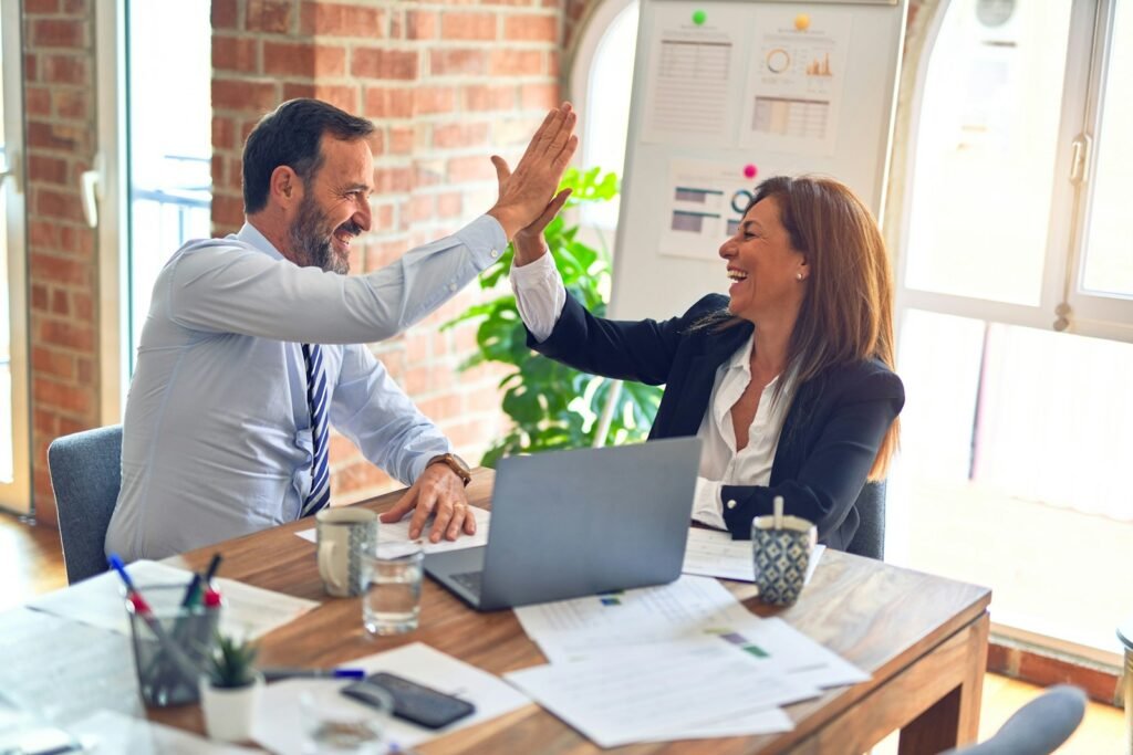 Client and agency high-fiving during an onboarding meeting