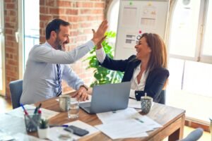 Client and agency high-fiving during an onboarding meeting