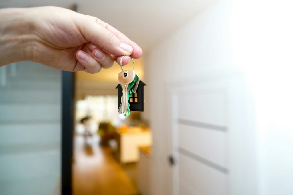 Property agent handing over house keys, representing digital marketing for property agents