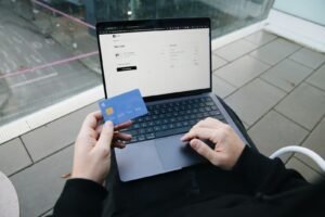Shopper holding a card at an online checkout page, illustrating ecommerce conversion optimisation