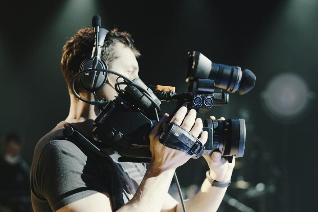 Event videographer filming with a professional camcorder