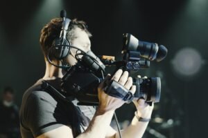Event videographer filming with a professional camcorder