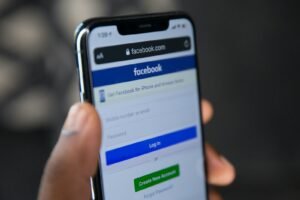 Facebook app open on a smartphone, representing Facebook ads packages