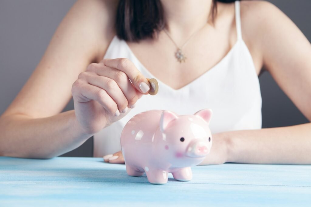 Woman putting a coin into a piggy bank, representing affordable SEO services