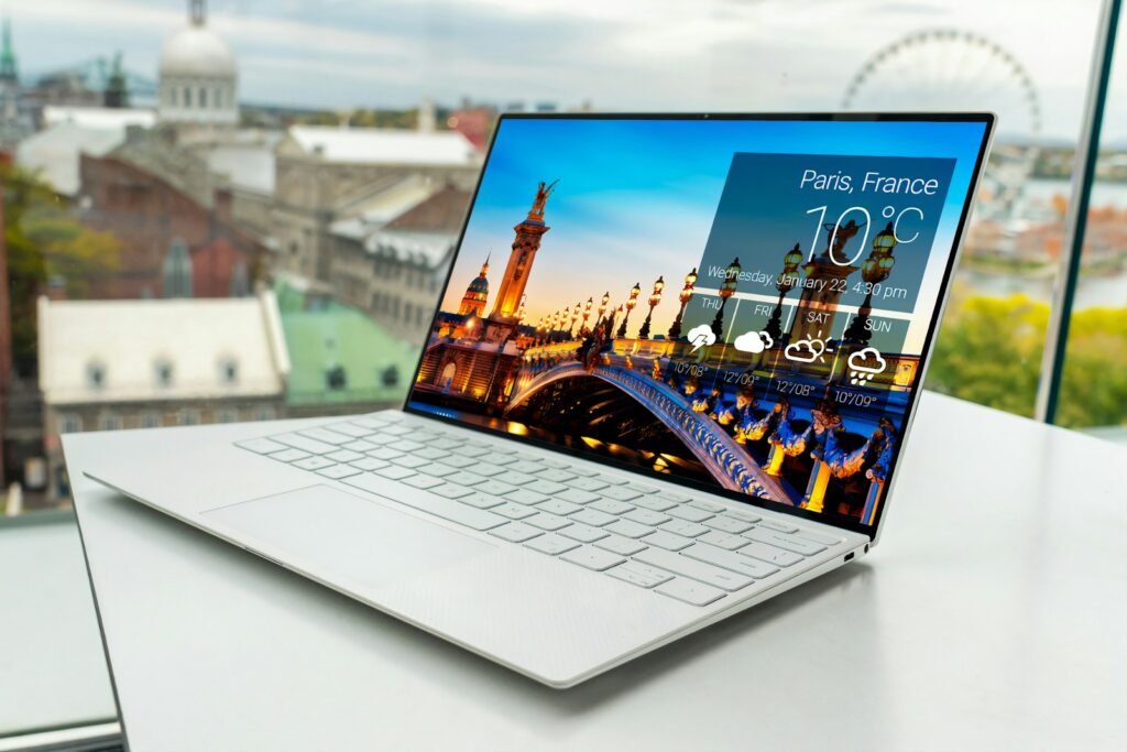 Laptop on a desk by a window, representing ecommerce website design