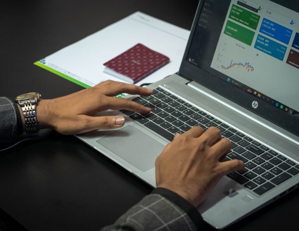Singapore marketing manager learning Google Ads campaign setup and reviewing keyword and budget data on a laptop.
