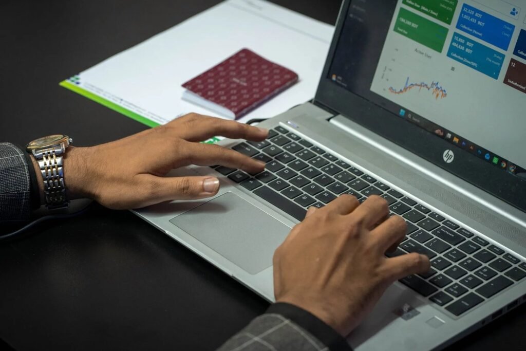 Singapore marketing manager learning Google Ads campaign setup and reviewing keyword and budget data on a laptop.