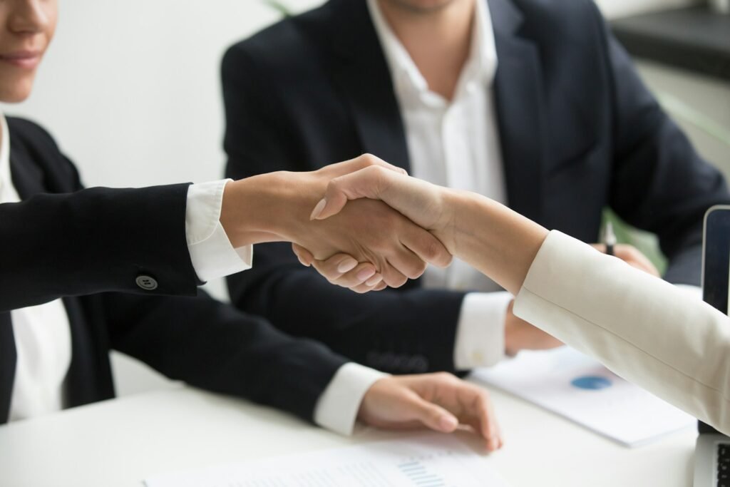 Business handshake over a desk, representing hiring a digital marketing company