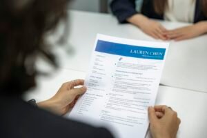 Hiring manager reviewing a resume while hiring an SEO expert