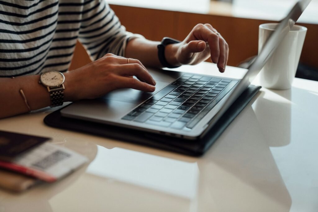 Writer typing a blog post on a laptop