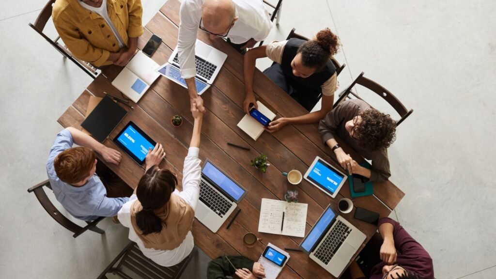 A Singapore Instagram marketing agency team reviewing a client content grid and shot list on a studio monitor.