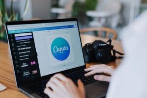 Designer creating a logo concept for a Singapore SME using design software on a laptop.