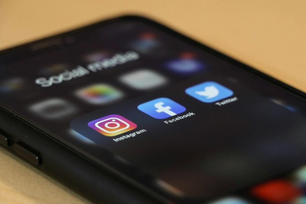 Smartphone showing Facebook and Instagram apps used for social media advertising