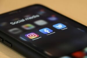 Smartphone showing Facebook and Instagram apps used for social media advertising