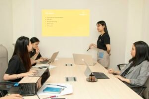 Marketing agency team presenting a proposal to colleagues around a meeting table